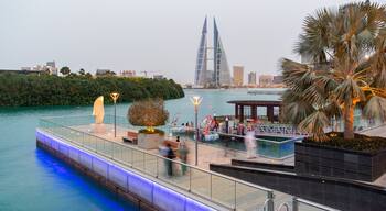 Manama which includes modern architecture, a high rise building and a bay or harbor