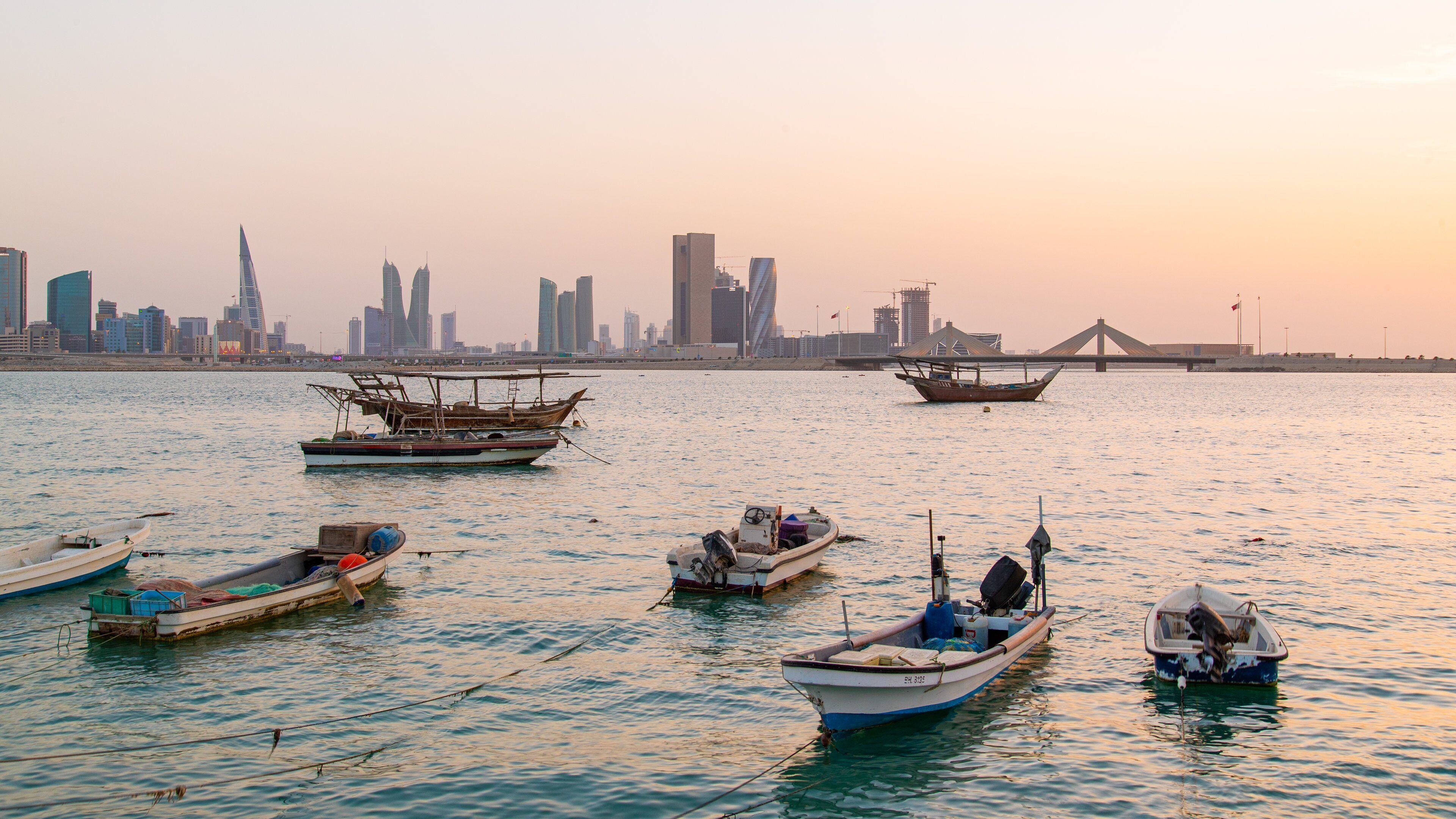 Manama showing a bay or harbor, a city and a sunset