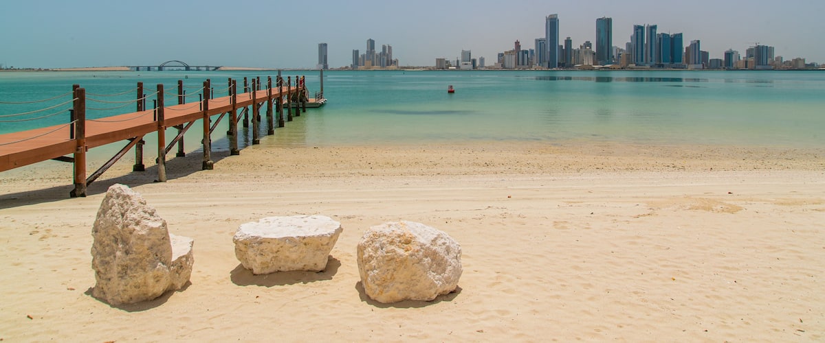 Manama showing a beach and general coastal views
