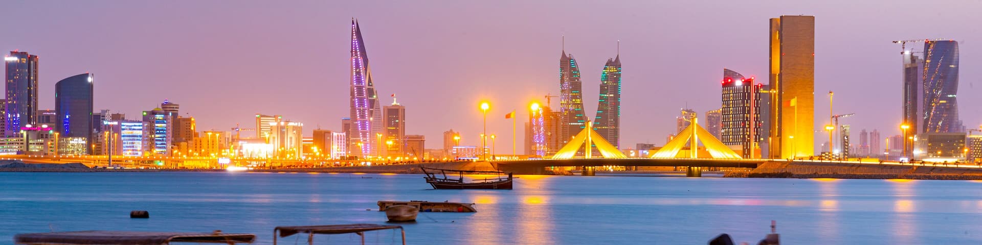 Manama showing a city, a bay or harbor and night scenes