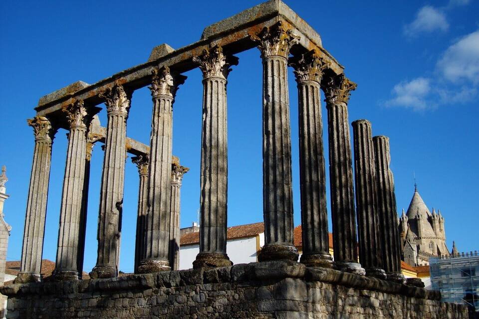 Ancient Roman columns with a clear blue sky in the background.