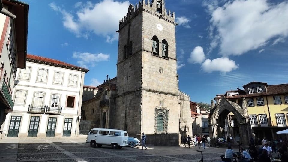 Igreja de Nossa Senhora da Oliveira is a collegiate church in Guimarães, Portugal. It is classified as a National Monument. Iconic carvings and art found within this intimate and beautiful Church, with a Romanesque arched nave. Situated on the Largo da Oliveira Square, this is all that remains of the Monastery that the Castelo de Guimaraes was built to defend. The current church's cornerstone was laid 1/1/1384. The bell tower is in the Manueline style, and the Gothic Padrao do Salado Shrine presides over its entrance
