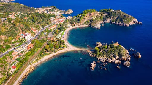 Aerial view of Isola Bella in Taormina, Sicily, Italy. Isola Bella is small island near Taormina, Sicily, Italy. Narrow path connects island to mainland Taormina beach in azure waters of Ionian Sea.