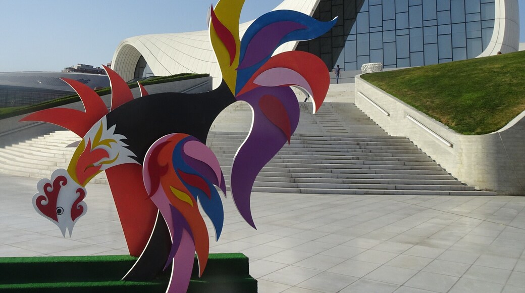 Modern Art in front of the Heydar Aliyev Centre.
The Centre, built in 2012 under the guidance of the legendary Iraqi-British architect Zaha Hadid (1950-2016) is famous for its smooth forms without sharp corners. Extending on eight floor levels, the centre accommodates an auditorium, temporary exhibition spaces, a conference centre and a museum. #Culture #Trovember