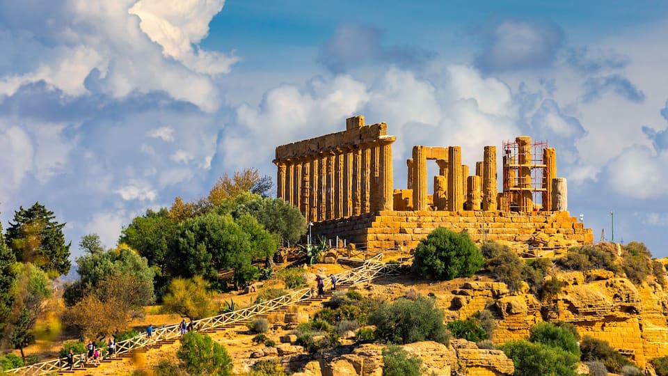 Ancient ruins on a hill with a clear sky.
