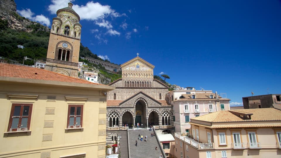 A church with a bell tower and a mountain in the background.
