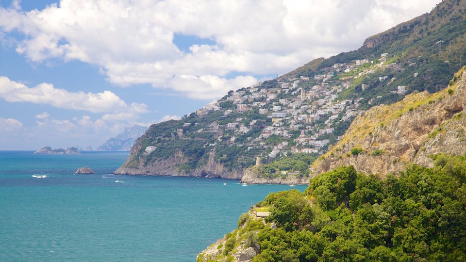A coastal town with buildings on a hillside overlooking the sea.