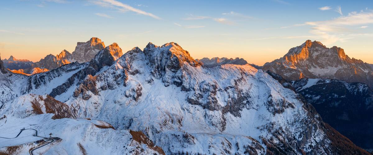 Panorama of the Dolomites mountains during autumn sunrise. Beautiful mountians of Alpi Dolomiti in Italy, South Tirol
