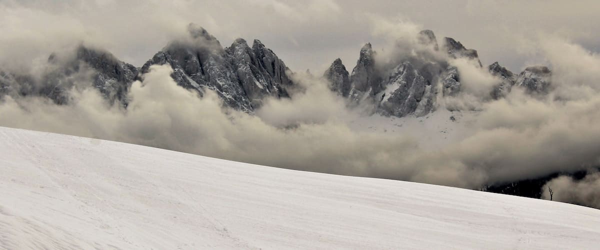 I took this in the legendary Dolomites! In Northern Italy, near Brixen/Bressanone. And this was from my last day in the Dolomites. And as far as beauty it was my favorite day! I loved seeing the fog in the mountains and valleys! And the beautiful winter forests :). This was one of my favorite viewpoints up there. I loved how low the fog was hanging! Yet also giving good views of the mountains. It was truly breathtaking to see. And this was only one of many spots around there. A great memory from December 2017!