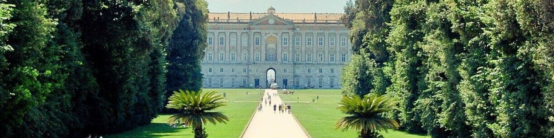 A grand palace with a symmetrical garden, a central pathway, and a fountain.