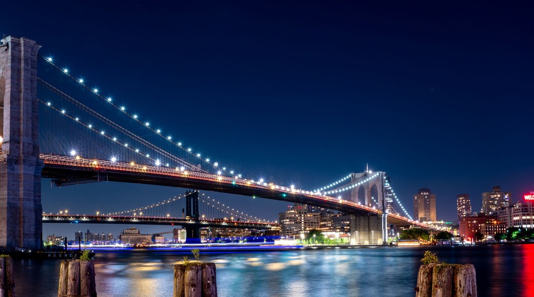 Wide Angle Panorama of the Brooklyn Bridge At Night With Clear Skies