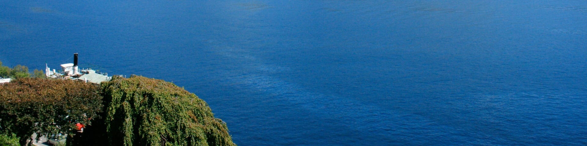 Como which includes a lake or waterhole, landscape views and mountains