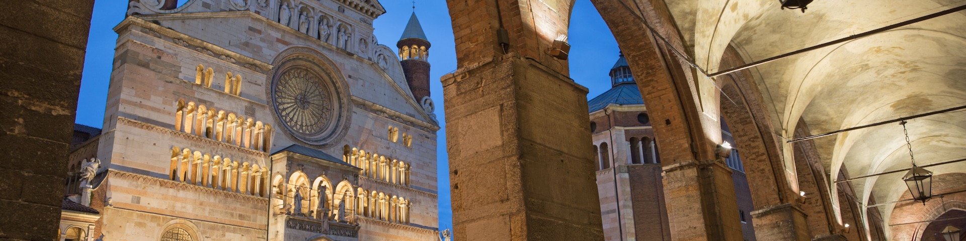CREMONA, ITALY - MAY 24, 2016: The cathedral Assumption of the Blessed Virgin Mary and the portico of the Town hall at dusk.