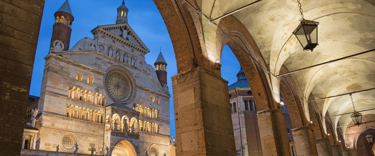 A historic building with arches and a large clock tower.
