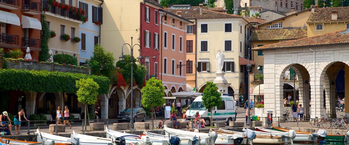 Desenzano del Garda which includes a bay or harbour, boating and street scenes