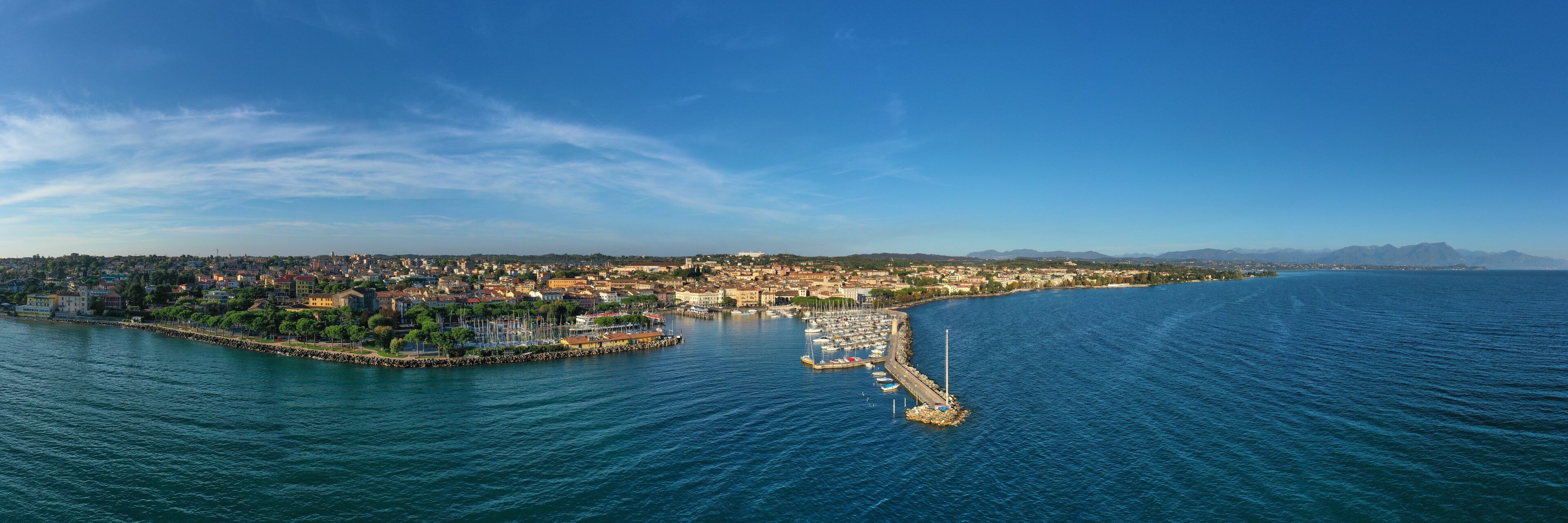 Aerial view of the city center of Desenzano del Garda, Italy. The main lighthouse of the city, boat parking in the city center