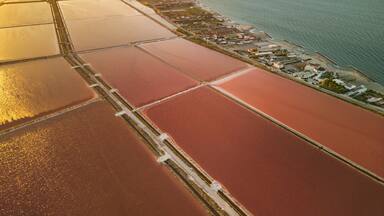 Aerial view of the Margherita di Savoia salt mines at sunset in Puglia, Italy