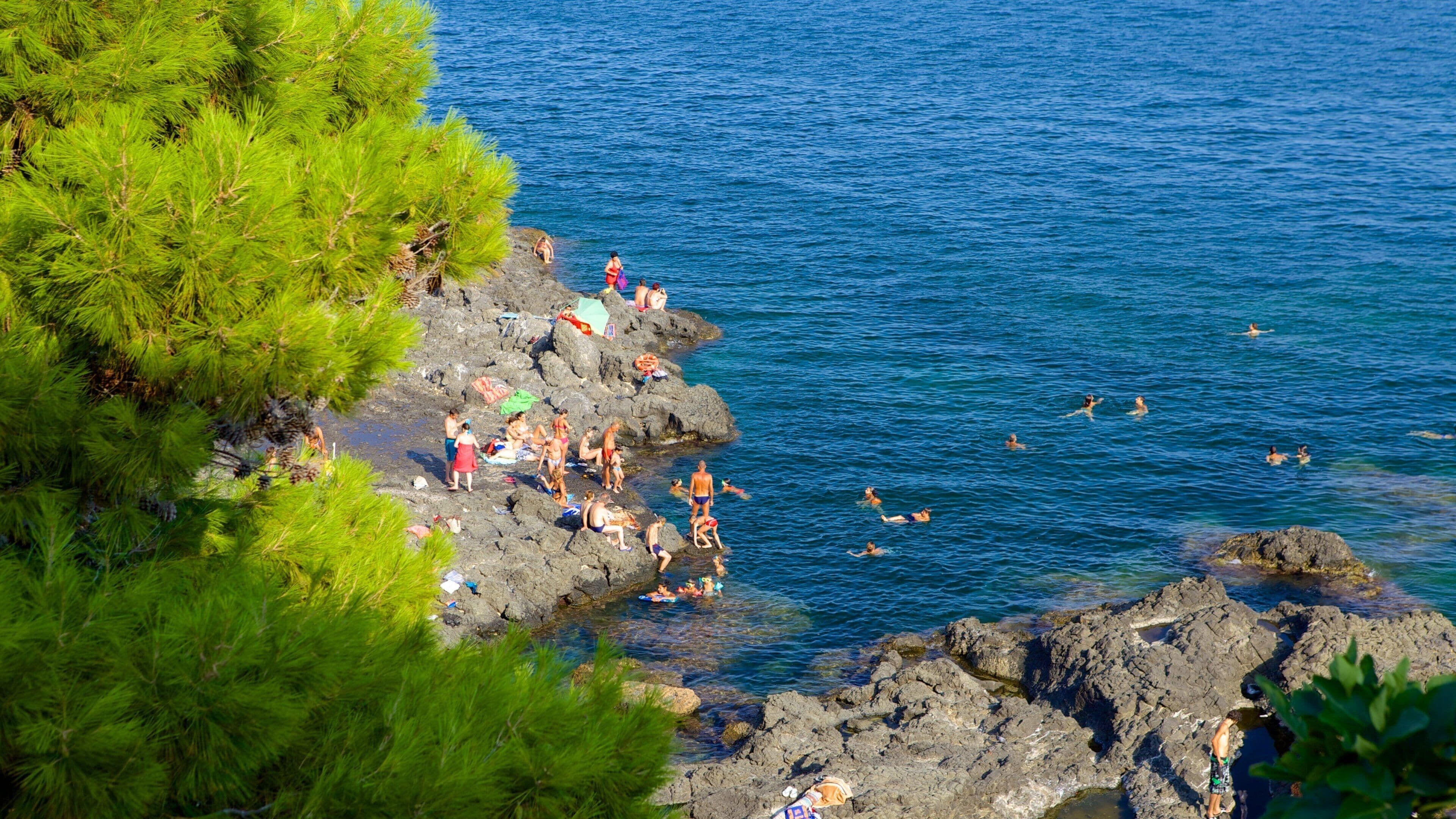Aci Castello which includes rugged coastline and swimming