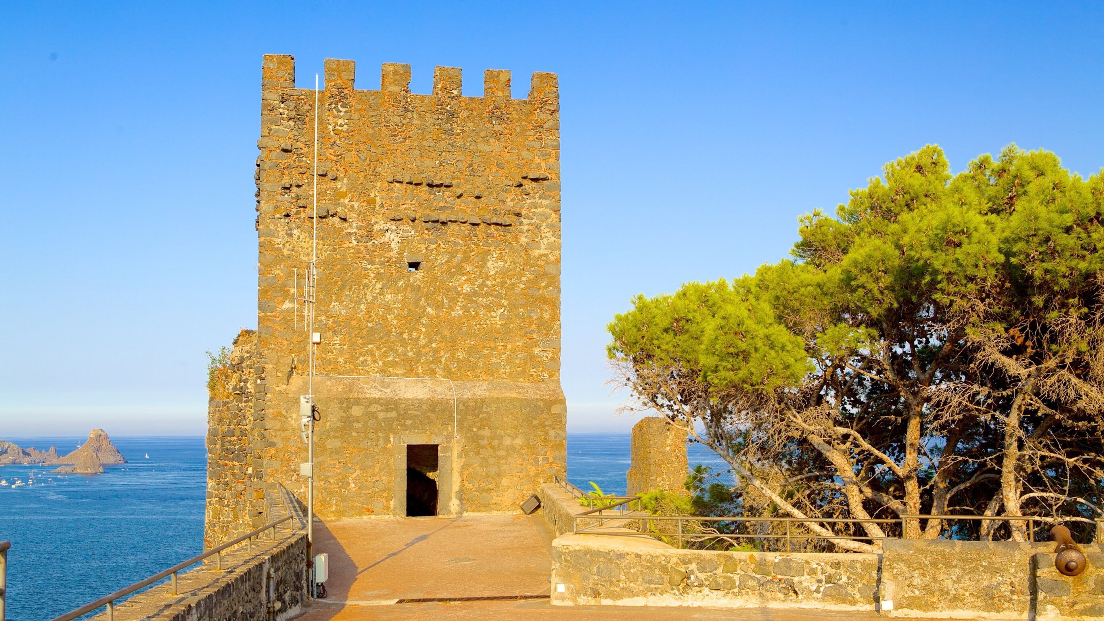 A stone tower with a portcullis, overlooking the sea.