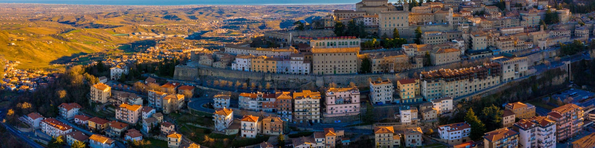 Beautiful aerial scenic view of Guaita fortress on Monte Titano with San Marino city in background at sunrise. Beautiful country of San Marino historical center. Castle on top of the hill.