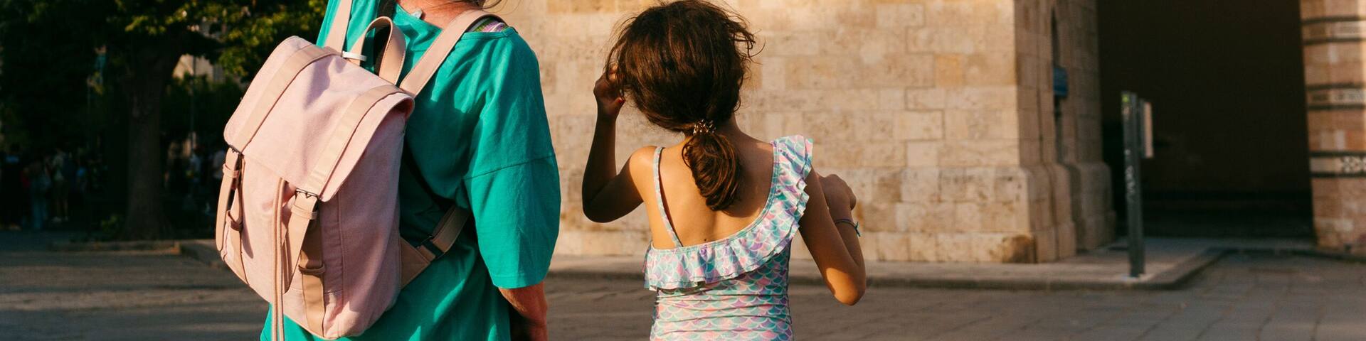 Kid and woman looking at the bell tower of the Messina Cathedral