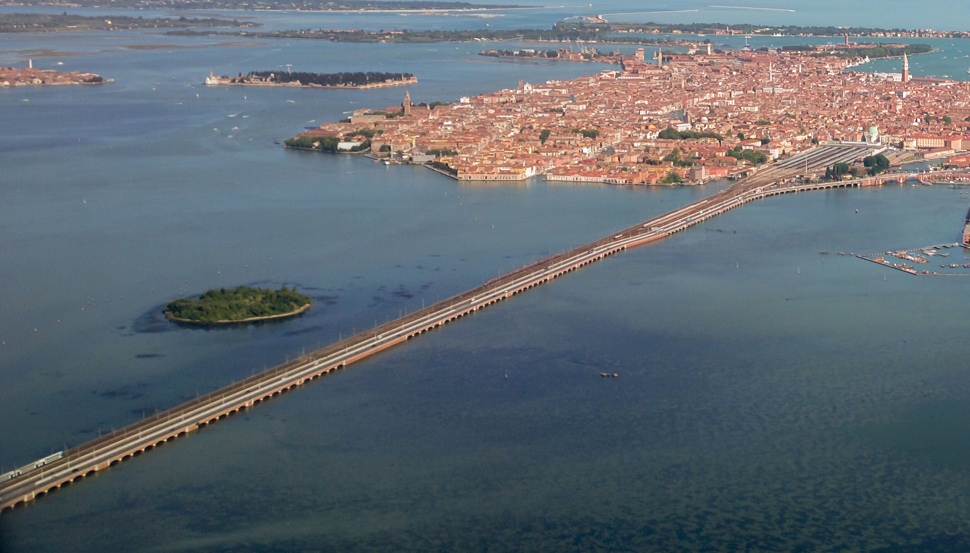 An aerial view of a city with a prominent bridge connecting two land masses.