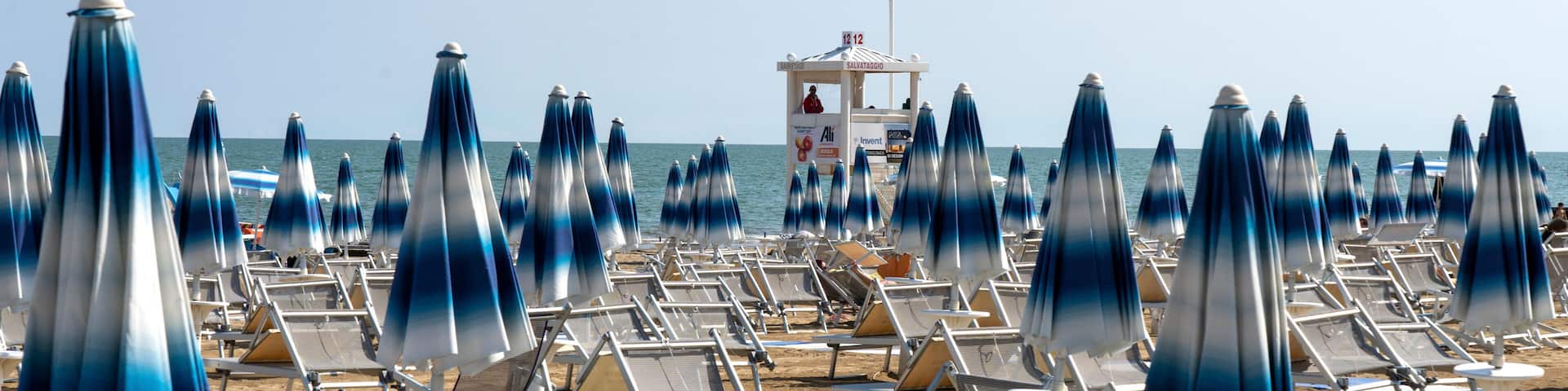 LIDO DI JESOLO, ITALY - May 24, 2019 : Umbrellas on the beach of Lido di Jesolo at adriatic Sea in a beautiful summer day, Italy. On the beach of Lido di Jesolo near Venice, Veneto region, Italy.