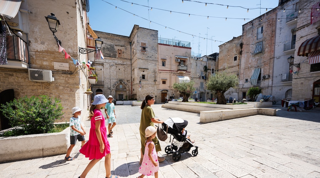 Family of tourists waking in streets Bari, Puglia, South Italy.