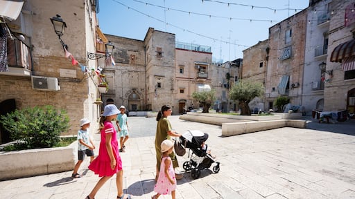 Family of tourists waking in streets Bari, Puglia, South Italy.