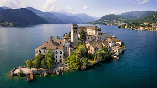 Most beautiful italian villages - unique romantic island San Giulio in Orta lake ( Lago di Orta) in Piedmont Province of Novara . aerial drone view