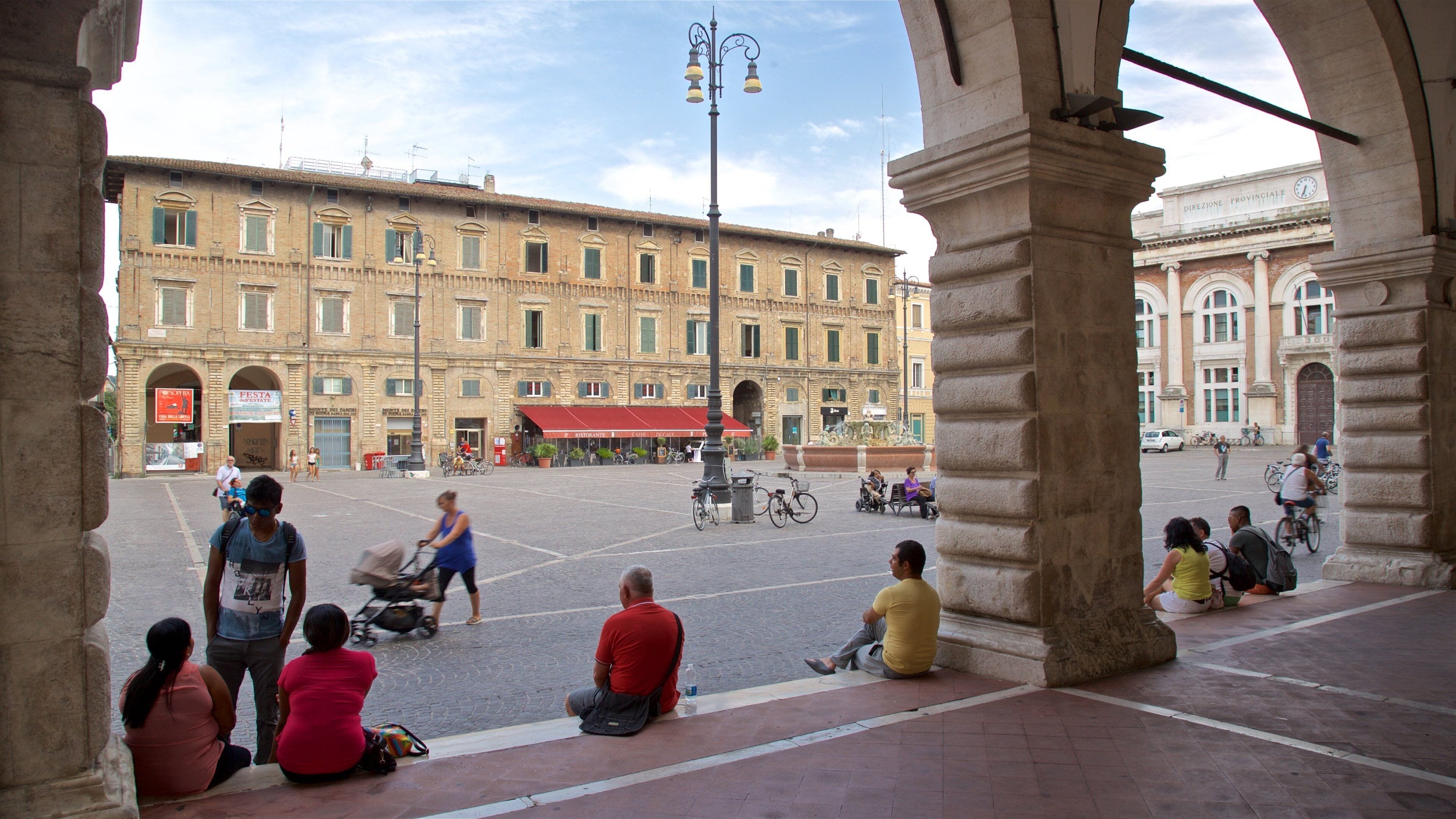 Pesaro showing a square or plaza as well as a small group of people