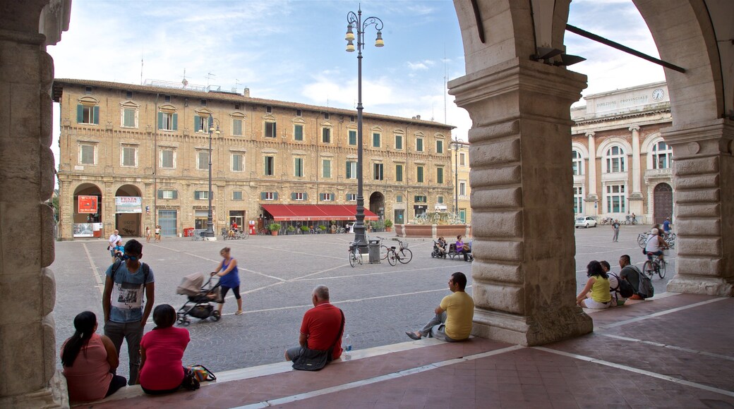 Pesaro showing a square or plaza as well as a small group of people