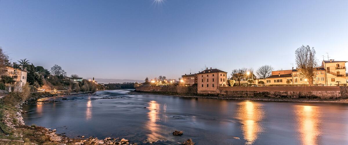 A river reflecting city lights at dusk.