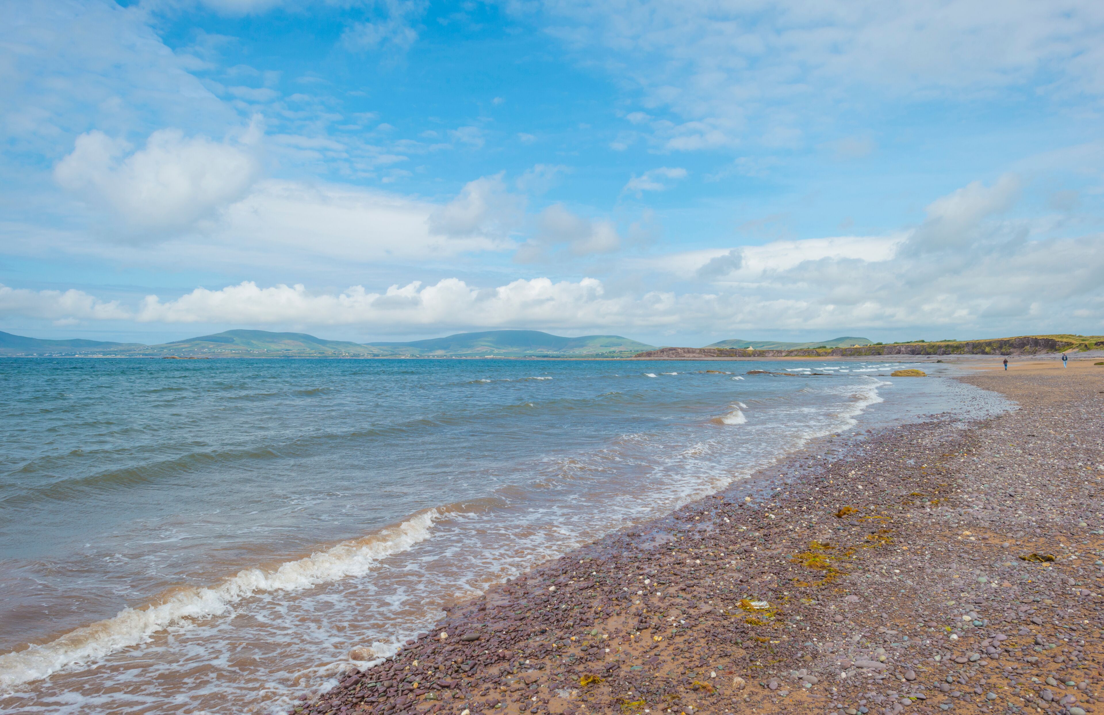 Beach along the atlantic ocean below a blue cloudy sky in summer
