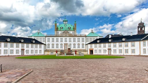 Fredensborg Palace in Denmark – royal residence with baroque architecture and courtyard under dramatic cloudy sky