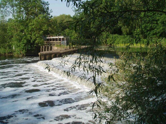 Um rio com uma barragem e uma ponte.