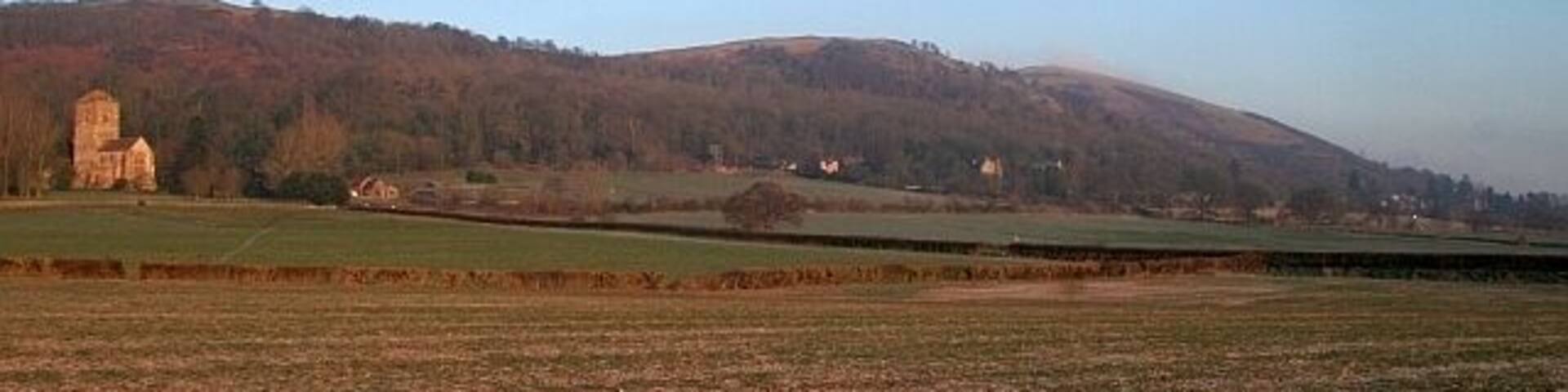 The Fields of Little Malvern A good view across the parish. From Little Malvern Priory to St Wulstans Roman Catholic Church with the Malvern Hills behind.