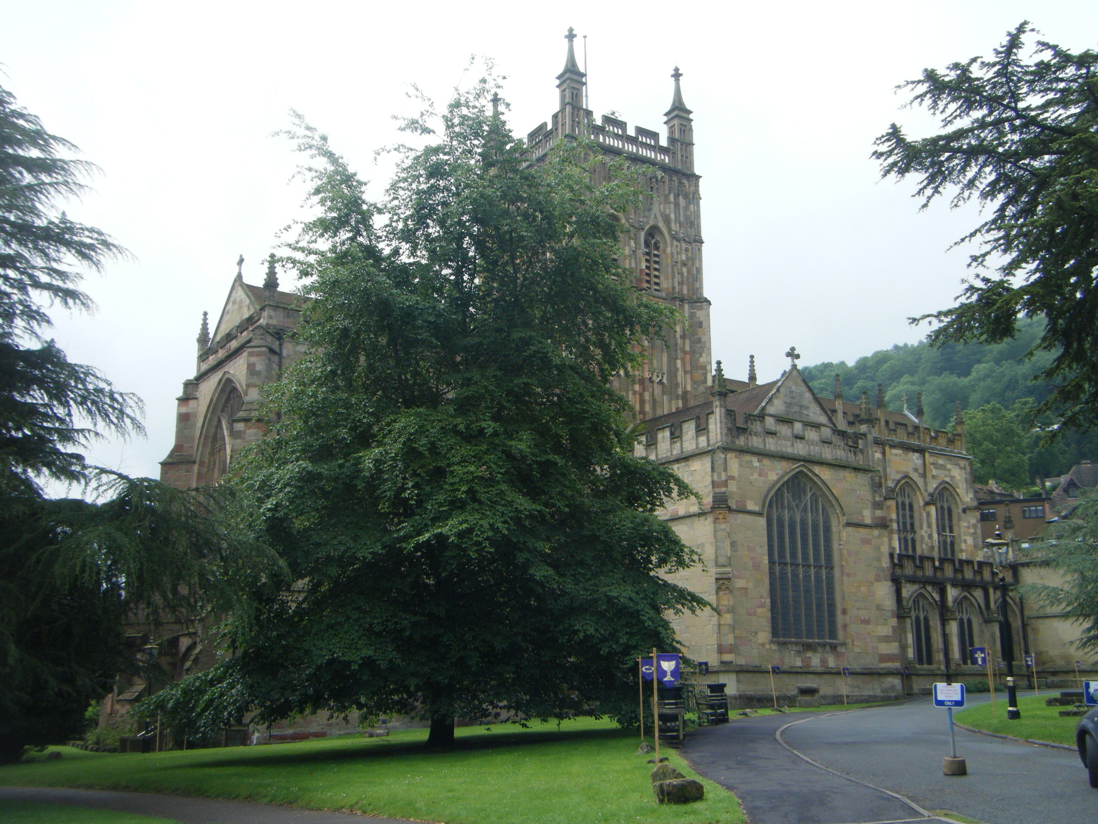 A historic church with a tall tower and large arched windows.