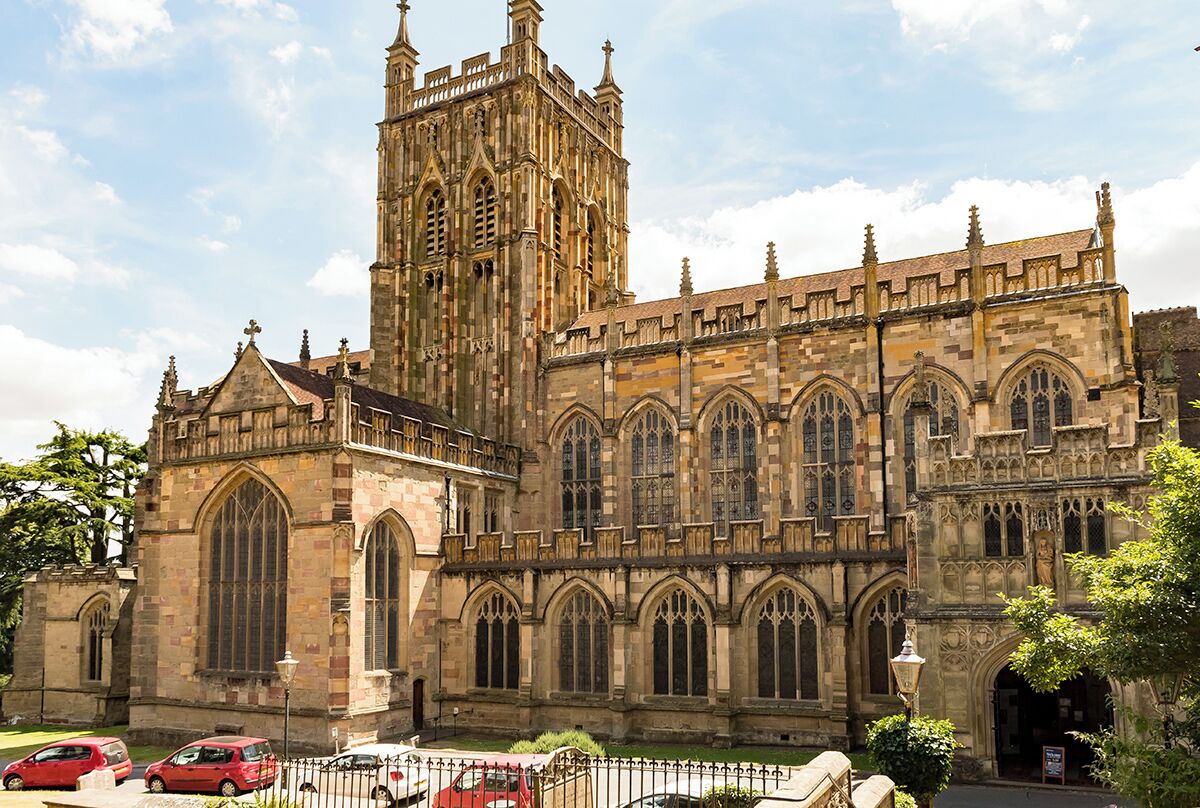 A large Gothic-style cathedral with a prominent tower and multiple arched windows.