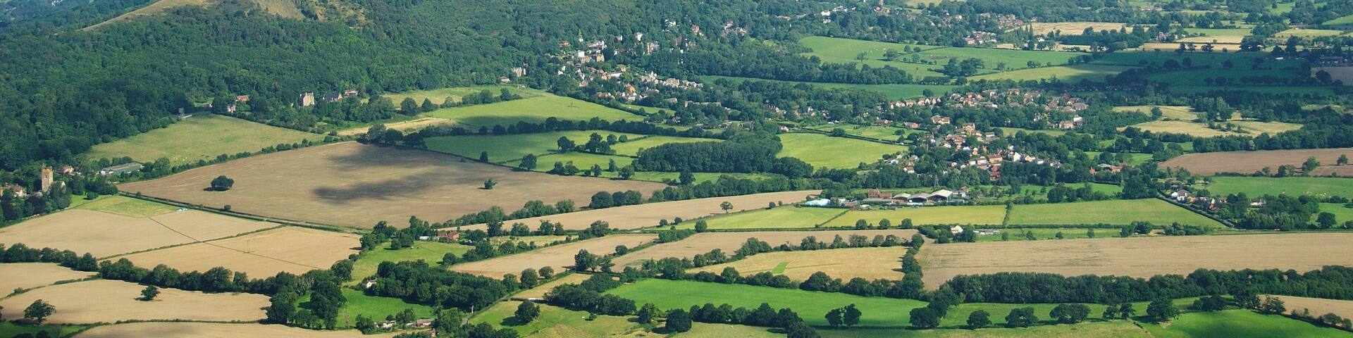 The Malvern Hills located in the English counties of Worcestershire and Herefordshire. The hills have been designated by the Countryside Agency as an Area of Outstanding Natural Beauty. The highest point is the Worcestershire Beacon at 425 metres (1,394 ft) above sea level. The range is a natural border between Worcestershire and Herefordshire.