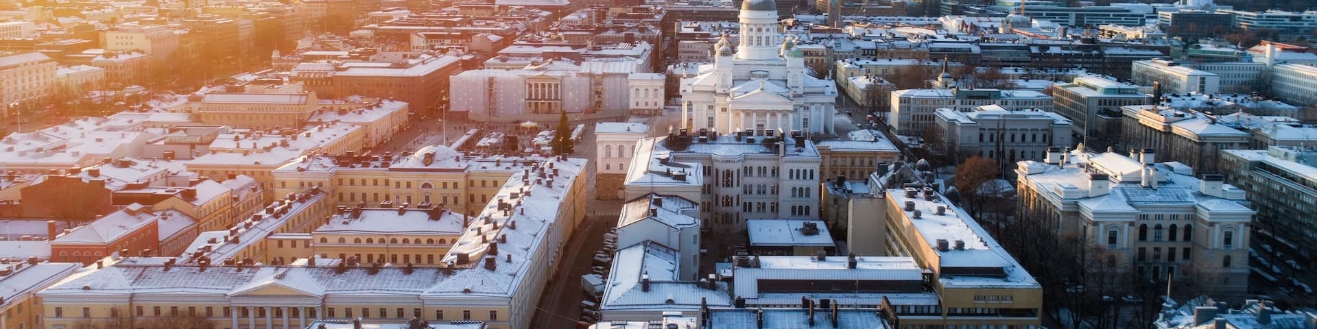 Winter susnset scenery of the Old Town in Helsinki, Finland. Snow on the roofs. Beautiful sunlight. Christmas market. View from above.