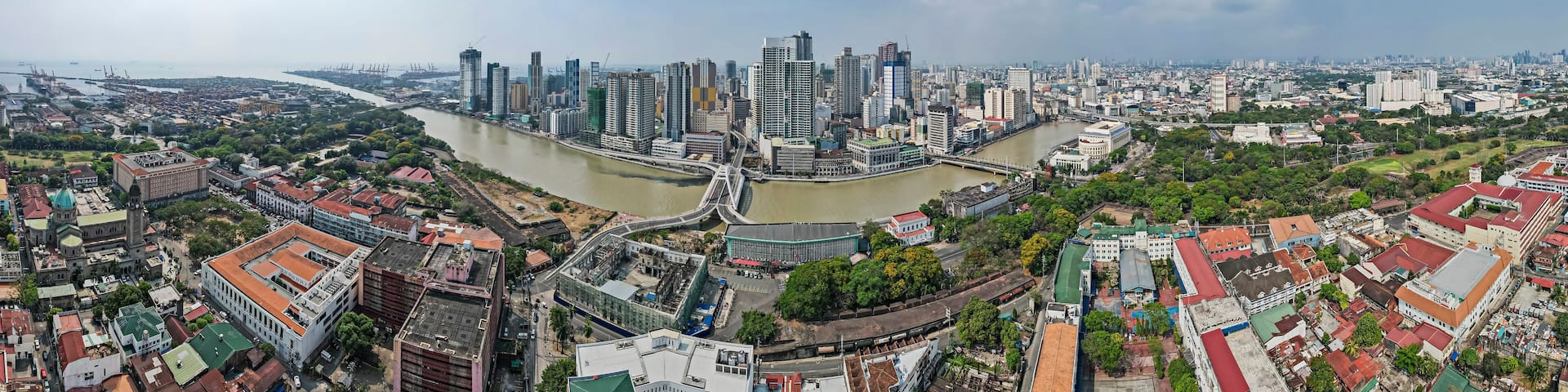 Manila, Philippines - Panoramic shot of the Binondo skyline and the Pasig river traversed by the Binondo - Intramuros Bridge.