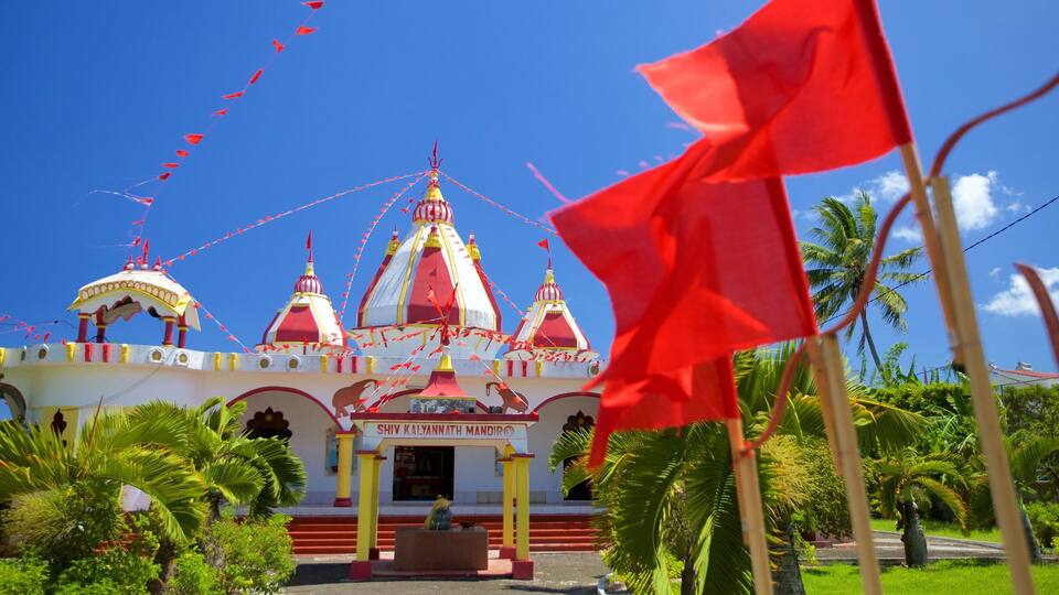 A temple with red and white domes and a sign reading "SHIV KALYANATH MANDIR".