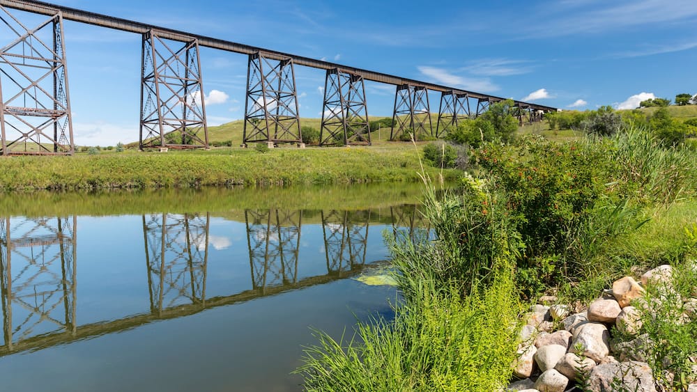 Railroad High Bridge / A long and tall railroad bridge reflecting in a river.