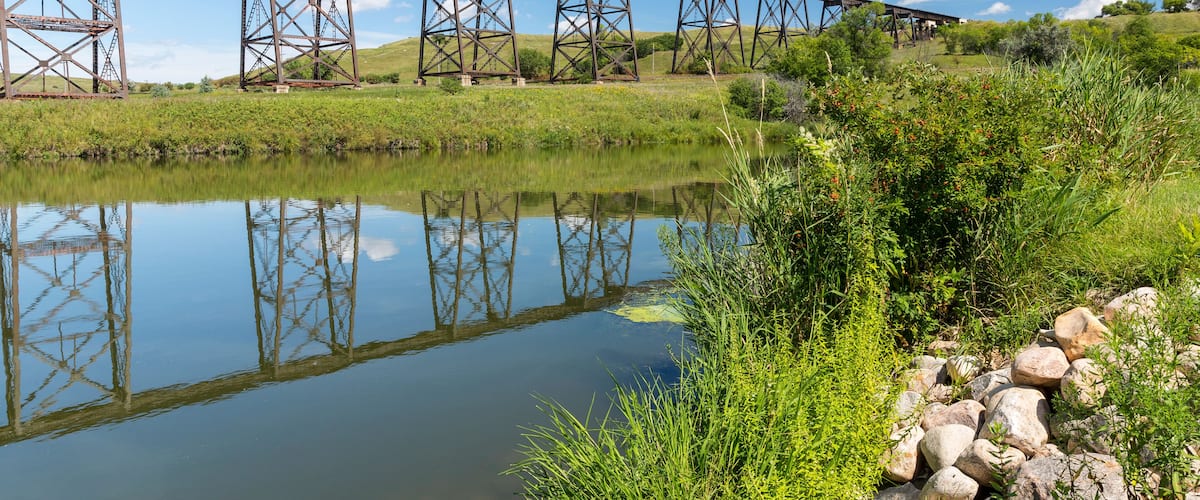 Railroad High Bridge / A long and tall railroad bridge reflecting in a river.