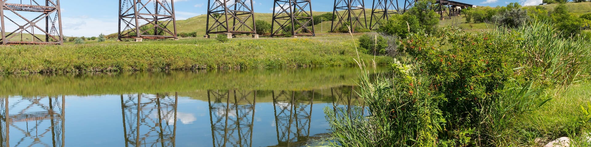 Railroad High Bridge / A long and tall railroad bridge reflecting in a river.