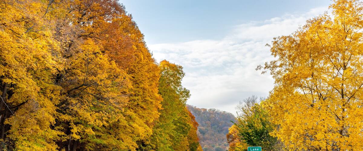 A road with a green sign for Lake Pepin.