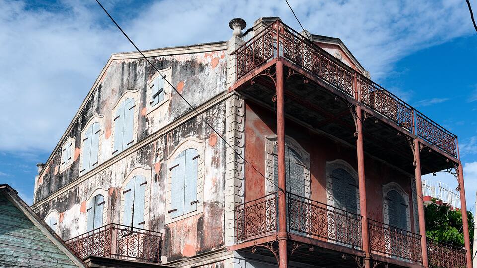 A historic building with ornate balconies and arched windows.