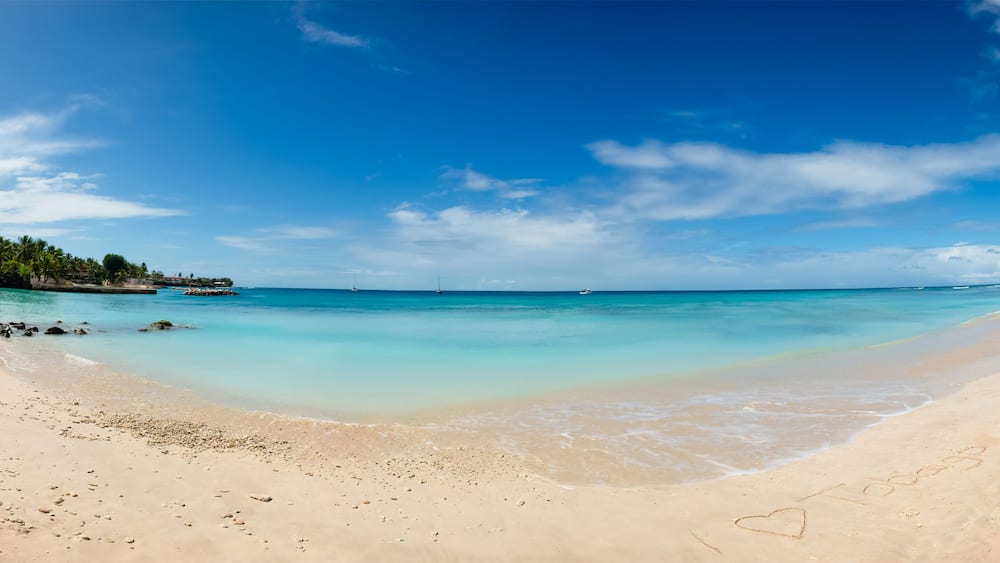 Tobago beach front panorama I love heart sign written sand