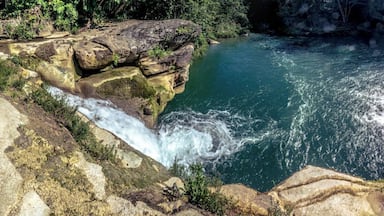 Well inside the Toledo District, in Belize, you'll find different indigenous communities and beautiful natural landscapes, like this double waterfall near Río Blanco.